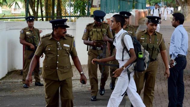 Sri Lankan police stand guard as school students return to classes as schools re-open across the country. Mid-to-upper stream classes resumed on Monday, to be followed by lower grades at a later date. (Ishara S. Kodikara / AFP) Sri Lankan police stand guard as school students return to classes as schools re-open across the country. Mid-to-upper stream classes resumed on Monday, to be followed by lower grades at a later date. (Ishara S. Kodikara / AFP)