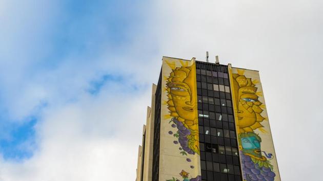 They go by the name “Un Kolor Distinto” (a different color) and have created huge works of art such as “Solsticio de verano” (summer solstice), a mural spanning all 22 floors of the Centenario building, one of the tallest in the city, with a surreal yellow face mixed with green and purple fruits and vegetables. It has now become one of the hottest spots on the tourist trail. (Martin Bernetti / AFP) They go by the name “Un Kolor Distinto” (a different color) and have created huge works of art such as “Solsticio de verano” (summer solstice), a mural spanning all 22 floors of the Centenario building, one of the tallest in the city, with a surreal yellow face mixed with green and purple fruits and vegetables. It has now become one of the hottest spots on the tourist trail. (Martin Bernetti / AFP)