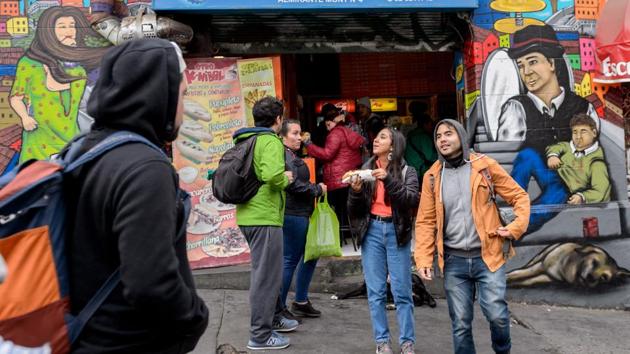 Tourists are seen in front of street murals in Valparaiso. “There are those very beautiful wall drawings, everything mixes well, it’s very beautiful,” 31-year-old Italian tourist Alessandro Ferssini said as he took a tour of the city’s graffiti circuit. Every month, around a thousand tourists take that tour. (Martin Bernetti / AFP) Tourists are seen in front of street murals in Valparaiso. “There are those very beautiful wall drawings, everything mixes well, it’s very beautiful,” 31-year-old Italian tourist Alessandro Ferssini said as he took a tour of the city’s graffiti circuit. Every month, around a thousand tourists take that tour. (Martin Bernetti / AFP)