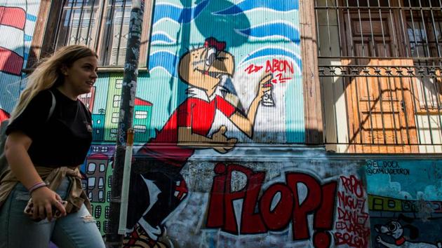 The couple have also painted murals on three more buildings in their distinctive colourful style that often contains written messages.While spray cans are their primary tools, they also use paint, oil and crayons to create the vivid colours that bring life to an imaginary world. (Martin Bernetti / AFP) The couple have also painted murals on three more buildings in their distinctive colourful style that often contains written messages.While spray cans are their primary tools, they also use paint, oil and crayons to create the vivid colours that bring life to an imaginary world. (Martin Bernetti / AFP)