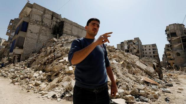 Mustafa Karim gestures in front of his destroyed house. Like the Aouls, they also left the district when the war came to Aleppo in 2012, and returned after the government recaptured it in December 2016. Their house was destroyed in the fierce battles in the month before the fighting ended. (Omar Sanadiki / REUTERS) Mustafa Karim gestures in front of his destroyed house. Like the Aouls, they also left the district when the war came to Aleppo in 2012, and returned after the government recaptured it in December 2016. Their house was destroyed in the fierce battles in the month before the fighting ended. (Omar Sanadiki / REUTERS)