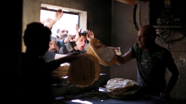 People queue to buy bread. The main street in this part of Aleppo’s Salahaddine district was the frontline. The Aoul and Karim houses were on the rebel side, bombarded with the army’s much heavier weaponry, including from the air. (Omar Sanadiki / REUTERS) People queue to buy bread. The main street in this part of Aleppo’s Salahaddine district was the frontline. The Aoul and Karim houses were on the rebel side, bombarded with the army’s much heavier weaponry, including from the air. (Omar Sanadiki / REUTERS)