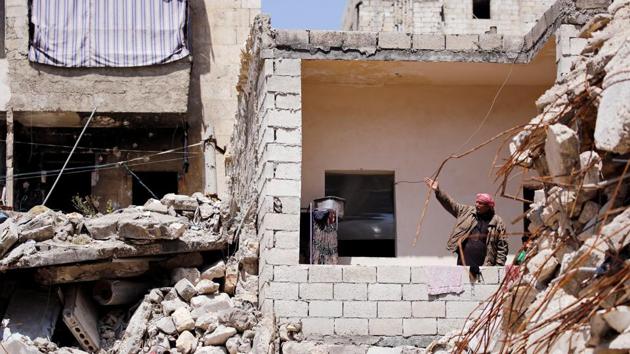 When Hassan Ahmed al-Aoul looks from his balcony in Aleppo, little meets his gaze but ruins - great mounds of rubble where his neighbours’ houses used to stand. Like many with homes near Aleppo’s frontlines, the city areas that suffered most damage in a war now into its ninth year, he makes do with a life in the rubble. (Omar Sanadiki / REUTERS) When Hassan Ahmed al-Aoul looks from his balcony in Aleppo, little meets his gaze but ruins - great mounds of rubble where his neighbours’ houses used to stand. Like many with homes near Aleppo’s frontlines, the city areas that suffered most damage in a war now into its ninth year, he makes do with a life in the rubble. (Omar Sanadiki / REUTERS)