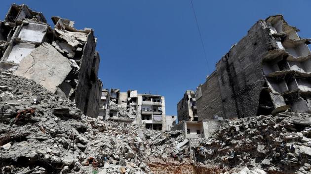 Their three rooms are furnished with mats, rugs, blankets and foam mattresses that double up as sofas and bedding. In the entranceway, coats hang next to a pink clock shaped like a teddy bear. The taller buildings on each side were either totally destroyed or damaged to the point of being uninhabitable. On the main street nearby, a collapse in February killed 11 people. (Omar Sanadiki / REUTERS) Their three rooms are furnished with mats, rugs, blankets and foam mattresses that double up as sofas and bedding. In the entranceway, coats hang next to a pink clock shaped like a teddy bear. The taller buildings on each side were either totally destroyed or damaged to the point of being uninhabitable. On the main street nearby, a collapse in February killed 11 people. (Omar Sanadiki / REUTERS)