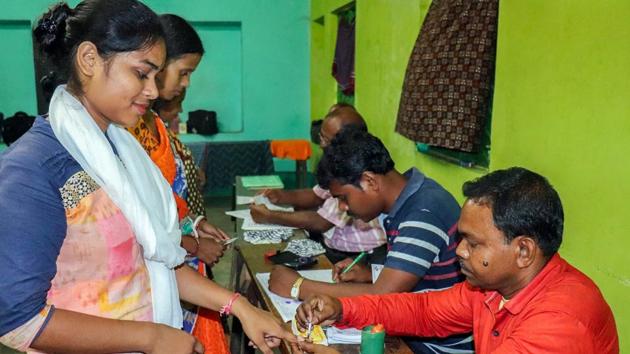 A voter gets her finger marked with indelible ink before casting her vote at a polling station in Madhya Pradesh.(PTI photo)