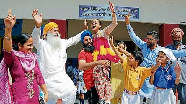 Khushpreet Kaur and her family celebrate after the Class-10 Punjab School Education Board result was declared on Wednesday (HT)