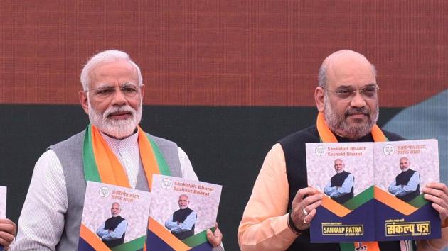 Prime Minister Narendra Modi along with Bharatiya Janata Party (BJP) president Amit Shah release BJP's manifesto for the upcoming general elections, at BJP headquarters, in New Delhi(Arvind Yadav/HT PHOTO)