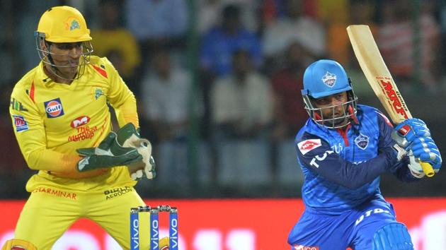 Delhi Capitals cricketer Prithvi Shaw plays a shot as Chennai Super Kings skipper MS Dhoni looks on.(AFP)