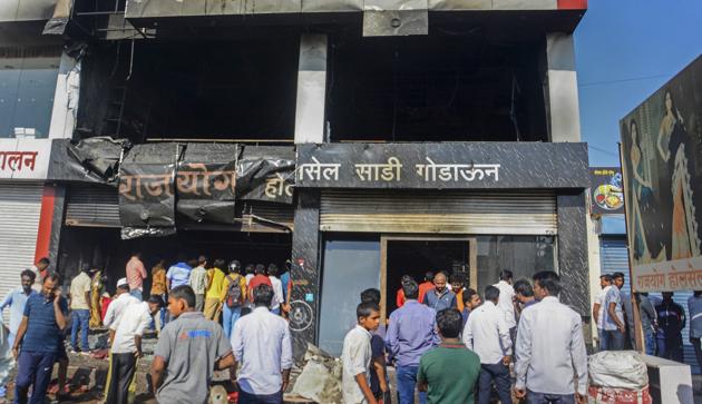 People look at the charred remains of a burnt shop in Uruli Devachi village near Pune. At least five labourers were killed in the fire. (PTI) People look at the charred remains of a burnt shop in Uruli Devachi village near Pune. At least five labourers were killed in the fire. (PTI)