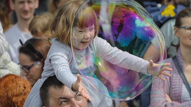 A child reaches for a soap bubble during the Global Bubble Parade in Bucharest, Romania. (Vadim Ghirda / AP) A child reaches for a soap bubble during the Global Bubble Parade in Bucharest, Romania. (Vadim Ghirda / AP)