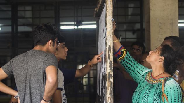 Students and parents check the first merit list of FYJC at a college in the city in 2018. (HT File) Students and parents check the first merit list of FYJC at a college in the city in 2018. (HT File)