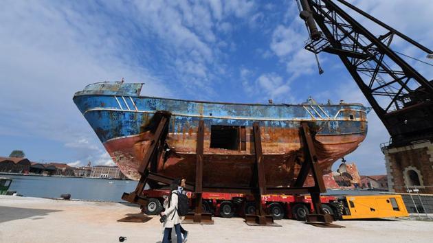 Swiss artist Christoph Buechel transported a hulking smugglers’ ship where 700 migrants perished in April 2015 to the edge of the Arsenale, exposing to viewers the gaping holes in the hull that caused it to sink in the Mediterranean. (Tiziana Fabi / AFP)