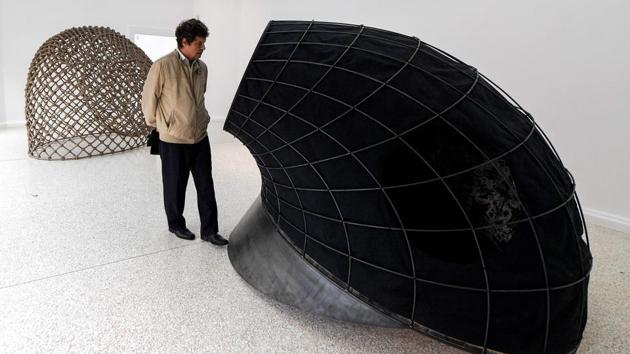 A visitor views an artwork as part of Martin Puryear's "Liberty". American Martin Puryear explores liberty through a series of clear, declarative sculptures and installations that are a rebuke against racism and testosterone-driven power. (Tiziana Fabi / AFP)