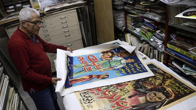 Abboudi Abu Jawdeh shows part of his vintage cinema poster collection at his office in the Lebanese capital Beirut. At a Beirut cultural centre, Lebanese film buff Abboudi Abu Jawdeh is exhibiting vintage film posters from his collection that show off a lost art, but also offer insight into decades of Western cliches of the Arab world. (Joseph Eid / AFP) Abboudi Abu Jawdeh shows part of his vintage cinema poster collection at his office in the Lebanese capital Beirut. At a Beirut cultural centre, Lebanese film buff Abboudi Abu Jawdeh is exhibiting vintage film posters from his collection that show off a lost art, but also offer insight into decades of Western cliches of the Arab world. (Joseph Eid / AFP)