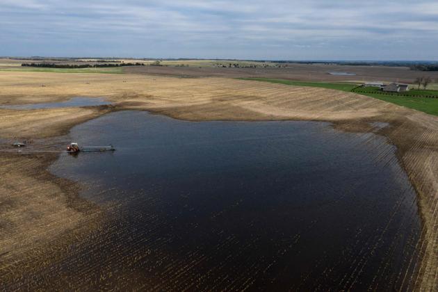 A tractor pumps water from a flooded field, near Orchard, Antelope County Nebraska. Already hurt by the US-China trade war, farmers in Nebraska are reeling from this year’s devastating floods, which ravaged crops and left little time to plant for the next harvest. Damage from the March rains in the Midwest is visible across the landscape north of Omaha, the state’s biggest city: trees have fallen, growing fields are caked in mud and rivers are at elevated levels. (Johannes Eisele / AFP) A tractor pumps water from a flooded field, near Orchard, Antelope County Nebraska. Already hurt by the US-China trade war, farmers in Nebraska are reeling from this year’s devastating floods, which ravaged crops and left little time to plant for the next harvest. Damage from the March rains in the Midwest is visible across the landscape north of Omaha, the state’s biggest city: trees have fallen, growing fields are caked in mud and rivers are at elevated levels. (Johannes Eisele / AFP)