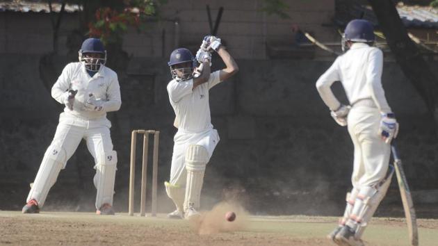 Deccan’s Atharva Khole hits a straight drive during the match against Ranjane at the Captain Shivrampant Vishnu Damle trophy cricket tournament at Katariya high school ground on Monday.(RAVINDRA JOSHI/HT PHOTO)