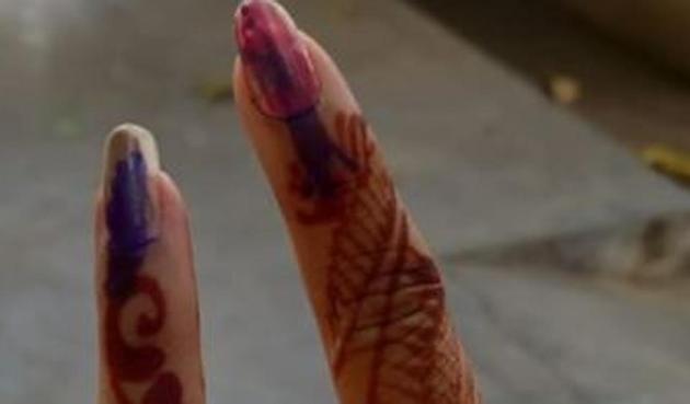 Women applied henna and take a manicure before voting on Sunday.