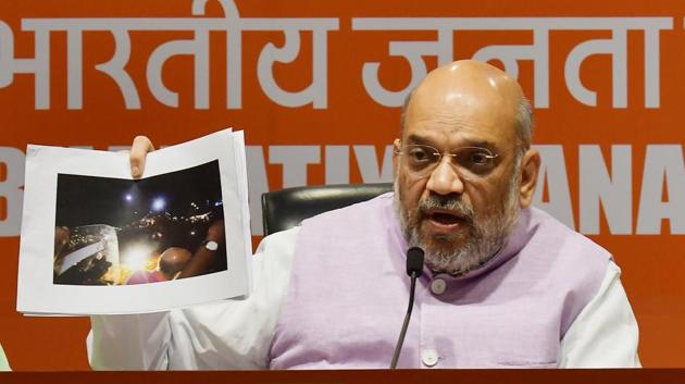 BJP chief Amit Shah accused the Trinamool Congress of orchestrating violence during his roadshow in Kolkata, presenting photographs to prove his point as the TMC, BJP sparring intensified in the slog overs of the Lok Sabha elections. “We will not be intimidated by violence… Anger of Bengalis will translate into defeat for Mamata didi who is stifling democracy in the state,” the BJP chief said. (Raj K Raj / HT Photo)