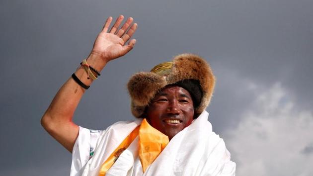 Kami Rita Sherpa, 48, a Nepali mountaineer waves towards the media personnel upon his arrival after climbing Mount Everest for a 22nd time, creating a new record for the most summits of the world's highest mountain, in Kathmandu, Nepal. (REUTERS)