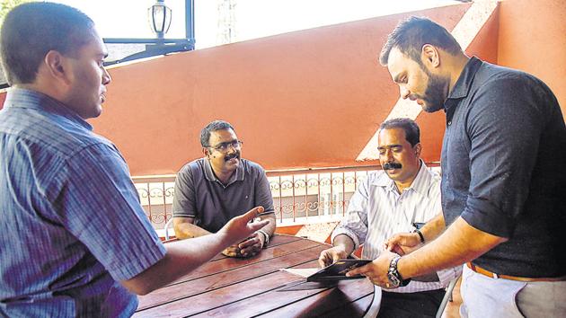 Rony george(left) founder director of NGO Chaitanya Mental Helath Institute interacting with staff members at the South East Cafe in Koregaon Park.(SANKET WANKHADE/HT PHOTO)