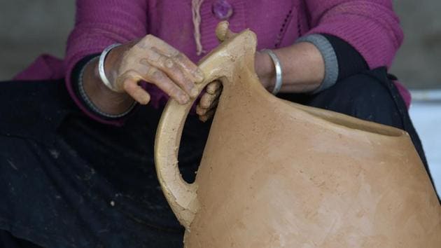 There are no sophisticated tools used, no modern ovens, just the sole of a shoe for the burnishing process and a stick for decorating the pieces with the juice of leaves collected from mastic trees. The items are then heated on an open hearth fired by dried dung, turning the juice from green to black. “This is how all kitchen utensils were made when I was little,” says Ayari. “They didn’t realise the value of these objects.” (Fethi Belaid / AFP) 
