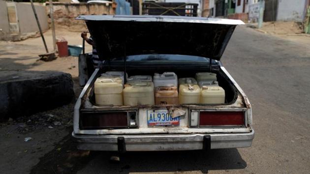 Lino Lopez (not pictured), who has kidney disease, uses his car to collect water during a blackout. There are few places that have been harder-hit than sweltering Maracaibo, the country’s second-largest city, which still experiences power cuts lasting 10 hours or more per day. That has led to water shortages, making it hard to provide the minimum 120 liters (32 gallons) of water doctors say is needed for a full dialysis session. (Ueslei Marcelino / REUTERS)