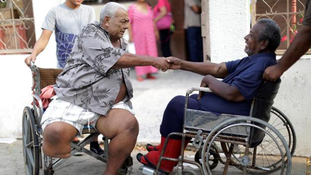 Elimenes Fuenmayor, 65, a patient with kidney disease, greets another kidney disease patient, as they wait for the electricity to return during a blackout. There are only 18 of 35 dialysis machines working in privately-owned dialysis center and the situation is similar at the 136 state-owned dialysis clinics across the country, said Carlos Marquez, the president of the Venezuelan Nephrology Society. Many of the country’s 1,600 machines are not working, he said. (Ueslei Marcelino / REUTERS)