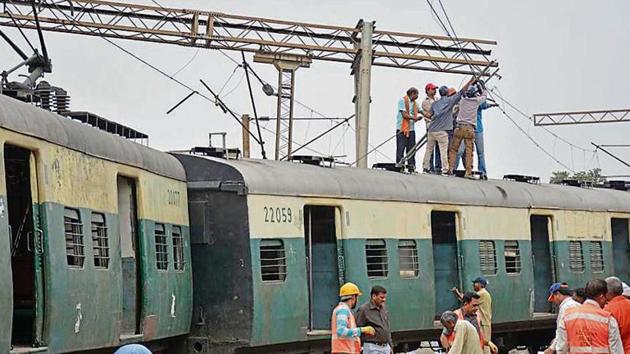 Members of the Accident Relief Staff in action as the second last coach of an EMU passenger train derailed in the morning, at Ghaziabad Railway Station, in Ghaziabad, India, on Thursday(Sakib Ali / Hindustan Times)