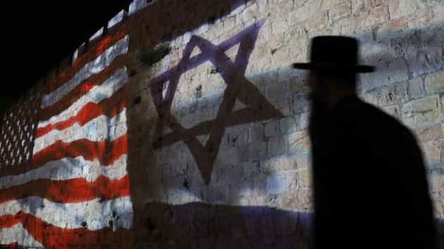 The Israeli and United States flags are projected on the walls of the ramparts of Jerusalem's Old City, to mark one year since the transfer of the US Embassy from Tel Aviv to Jerusalem. (Ahmad Gharabli / AFP) The Israeli and United States flags are projected on the walls of the ramparts of Jerusalem's Old City, to mark one year since the transfer of the US Embassy from Tel Aviv to Jerusalem. (Ahmad Gharabli / AFP)