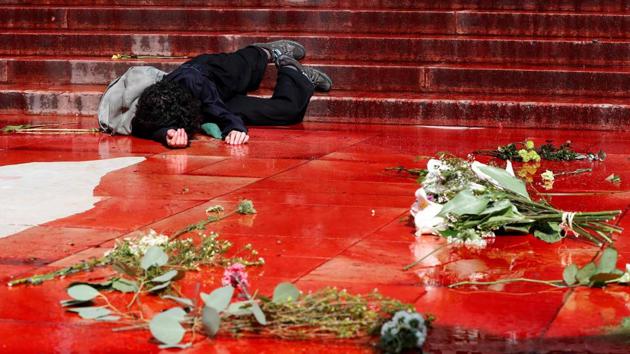 A member of the action group Extinction Rebellion lies on the ground in fake blood on the Trocadero esplanade during a demonstration to alert on the state of declining biodiversity in Paris. (Francois Guillot/ AFP) A member of the action group Extinction Rebellion lies on the ground in fake blood on the Trocadero esplanade during a demonstration to alert on the state of declining biodiversity in Paris. (Francois Guillot/ AFP)