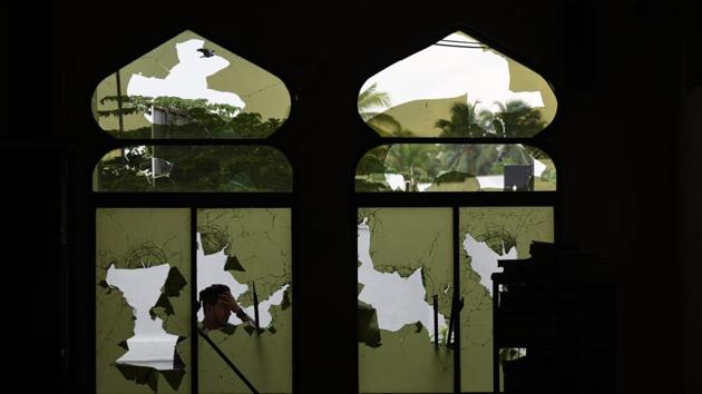 A man stands in front of the Jumha mosque after a mob attack in Minuwangoda, Sri Lanka. (Lakruwan Wanniarachchi / AFP) A man stands in front of the Jumha mosque after a mob attack in Minuwangoda, Sri Lanka. (Lakruwan Wanniarachchi / AFP)