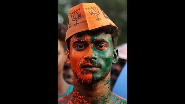 A supporter of India's ruling Bharatiya Janata Party (BJP) stands with his body painted as he attends an election rally. (Bikas Das / AP) A supporter of India's ruling Bharatiya Janata Party (BJP) stands with his body painted as he attends an election rally. (Bikas Das / AP)