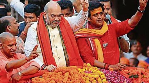 BJP President Amit Shah along with UP CM Yogi Adityanath and party candidate Ravi Kishan during a road show in Gorakhpur(ANI)