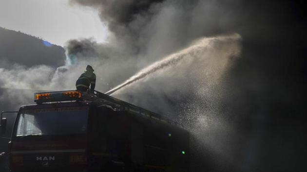 A Fire Fighter seen at a scrap godown in Thane Daighar, Maharashtra. (Rishikesh Choudhary / HT Photo) A Fire Fighter seen at a scrap godown in Thane Daighar, Maharashtra. (Rishikesh Choudhary / HT Photo)