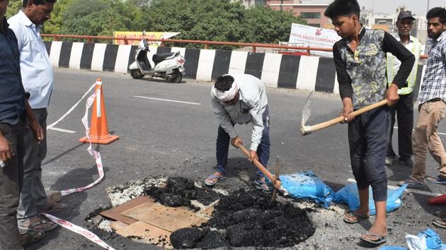 The flyover had suffered damages after chunks of concrete fell off the carriageway (Jaipur to Delhi side), leaving a large hole in the middle of the surface. This is the second time that the flyover had suffered damage on the same stretch within one year(Yogesh Kumar/Hindustan Times)