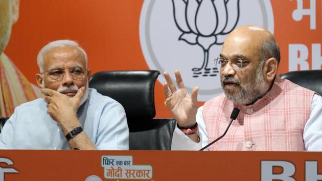 Amit Shah, president of Bharatiya Janata Party (BJP) speaks as Prime Minister Narendra Modi (L) watches him during a news conference at the BJP headquarters in New Delhi. (T. Narayan / Bloomberg) Amit Shah, president of Bharatiya Janata Party (BJP) speaks as Prime Minister Narendra Modi (L) watches him during a news conference at the BJP headquarters in New Delhi. (T. Narayan / Bloomberg)