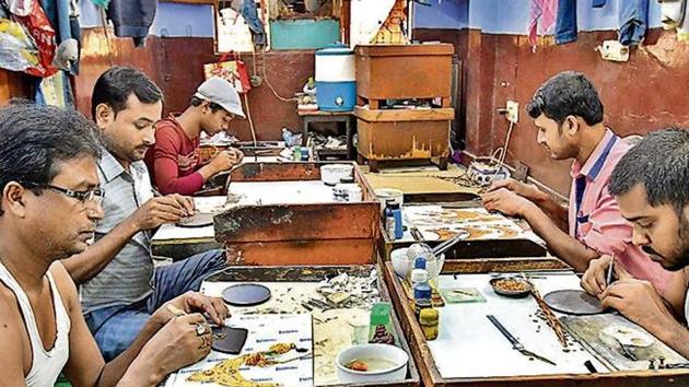Artisans at work at a small unit that handles gold and silver ornamental work in Regar Pura in Karol Bagh, in New Delhi(Raj K Raj/ Hindustan Times)