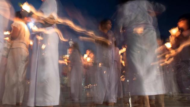 Devotees carry candles as they pray during the Vesak Day celebration , at a temple in Chonburi province, Thailand. (Athit Perawongmetha / REUTERS) Devotees carry candles as they pray during the Vesak Day celebration , at a temple in Chonburi province, Thailand. (Athit Perawongmetha / REUTERS)