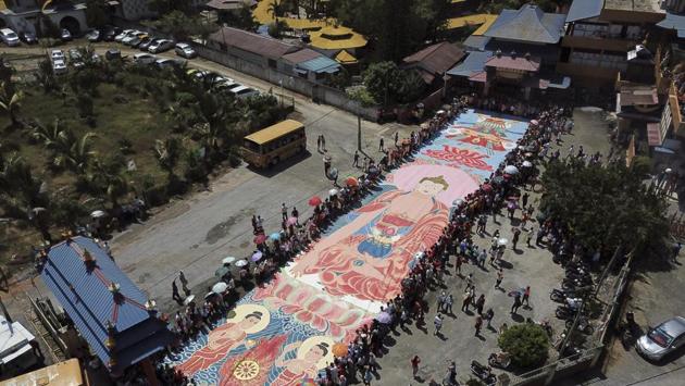 Devotees unveil a giant canvas of sacred "Thangka" measuring 60 meters (197 feet) by 12 meters (39 feet), under the sun during a Vesak Day celebration in Ipoh, Malaysia. Vesak Day is a global observance, as well as a public holiday recognized by the United Nations (UN) in many countries (Slamet Riyadi / AP) Devotees unveil a giant canvas of sacred "Thangka" measuring 60 meters (197 feet) by 12 meters (39 feet), under the sun during a Vesak Day celebration in Ipoh, Malaysia. Vesak Day is a global observance, as well as a public holiday recognized by the United Nations (UN) in many countries (Slamet Riyadi / AP)