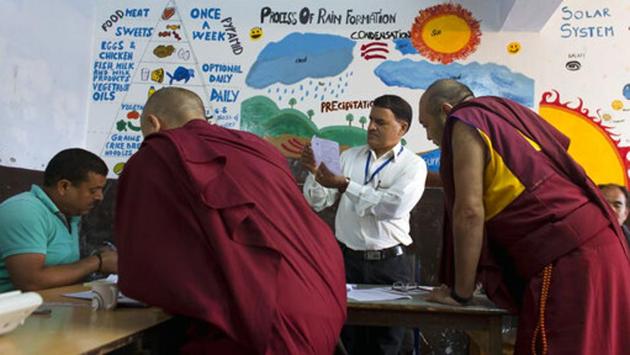 Exiled Tibetan monks get their documents verified by polling officials before casting their vote during the seventh and final phase of Indian national elections in Dharmsala, Himachal Pradesh. (Ashwini Bhatia / AP) Exiled Tibetan monks get their documents verified by polling officials before casting their vote during the seventh and final phase of Indian national elections in Dharmsala, Himachal Pradesh. (Ashwini Bhatia / AP)