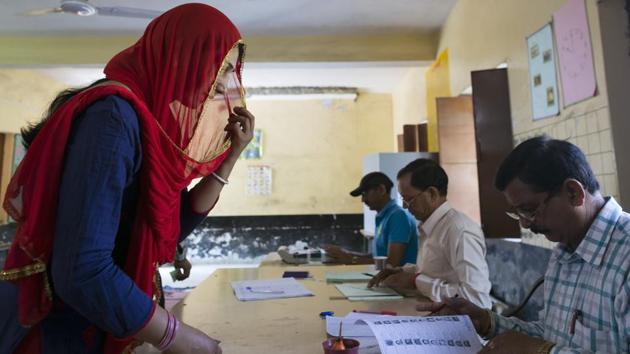 A polling official checks the name of a voter during the seventh and final phase of national elections in Dharamshala, Himachal Pradesh. It is set to be a high-stakes battle for both the ruling BJP and opposition Congress in the northern state where politics has broadly been bipolar. Riding on the Modi wave, the BJP had won all the four Lok Sabha seats — Mandi, Kangra, Shimla and Hamirpur — in the last general election in 2014. (Ashwini Bhatia / AP) A polling official checks the name of a voter during the seventh and final phase of national elections in Dharamshala, Himachal Pradesh. It is set to be a high-stakes battle for both the ruling BJP and opposition Congress in the northern state where politics has broadly been bipolar. Riding on the Modi wave, the BJP had won all the four Lok Sabha seats — Mandi, Kangra, Shimla and Hamirpur — in the last general election in 2014. (Ashwini Bhatia / AP)