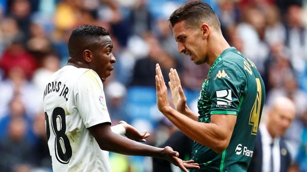 Real Madrid's Vinicius Junior and Real Betis' Zouhair Feddal react to each other.(REUTERS)