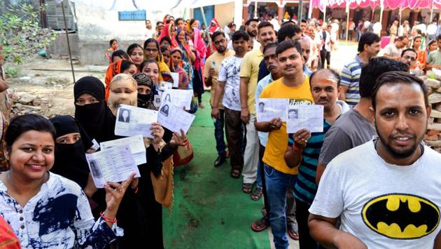 Voters wait in queues to cast their votes at a polling station in Varanasi, Uttar Pradesh. Prime Minister Narendra Modi’s Varanasi constituency looks largely predictable while the BJP is facing a tough fight in 13 Lok Sabha constituencies as it will largely be a straight fight between the BJP and the SP-BSP alliance on ten seats. (PTI) Voters wait in queues to cast their votes at a polling station in Varanasi, Uttar Pradesh. Prime Minister Narendra Modi’s Varanasi constituency looks largely predictable while the BJP is facing a tough fight in 13 Lok Sabha constituencies as it will largely be a straight fight between the BJP and the SP-BSP alliance on ten seats. (PTI)