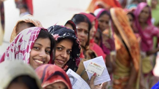 Varanasi: Voters wait in a queue to cast their votes at a polling station, during the seventh phase of Lok Sabha elections, at Jayapur village in Varanasi, Sunday, May 19, 2019. Jayapur, is one of the villages adopted by Prime Miniter Narendra Modi during a drive which began in 2014 under the Sansad Adarsh Gram Yojana. (PTI Photo/Atul Yadav) (PTI5_19_2019_000085A)(PTI)