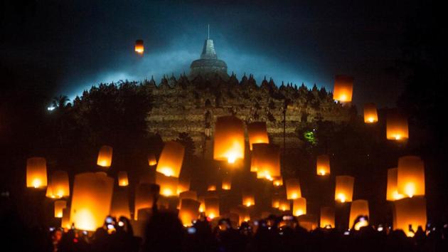 Visitors take photographs on their cellphones as the sky lanterns take flight outside the 9th century Borobudur temple. Some community groups also organize acts of charity, like releasing caged animals or donating food and gifts to the poor. (Andreas Fitri Atmoko / Indonesia Out / REUTERS) Visitors take photographs on their cellphones as the sky lanterns take flight outside the 9th century Borobudur temple. Some community groups also organize acts of charity, like releasing caged animals or donating food and gifts to the poor. (Andreas Fitri Atmoko / Indonesia Out / REUTERS)