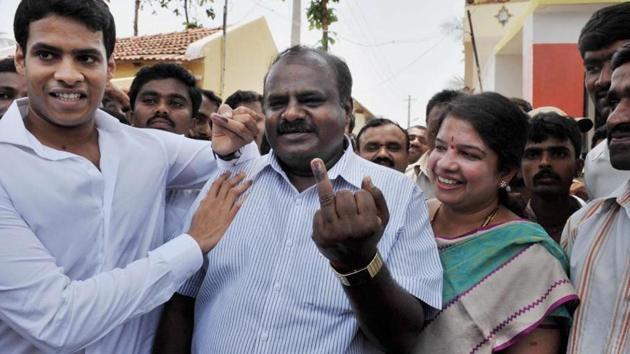 JD(S) state president H D Kumaraswamy, wife and Ramanagara MLA, Anita Kumaraswamy and son Nikhil in Ramanagara in Karnataka.(PTI Photo)