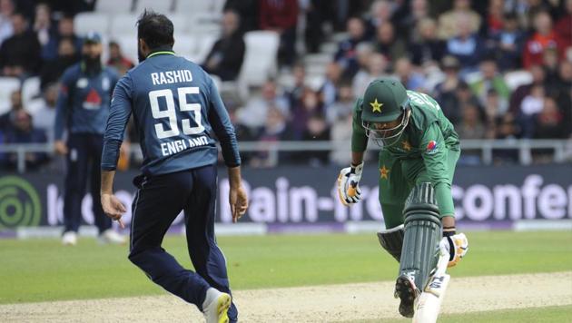 Pakistan's Babar Azam, right, is run out by England's Adil Rashid, left, during the Fifth One Day International cricket match between England and Pakistan at Emerald Headingley in Leeds(AP)