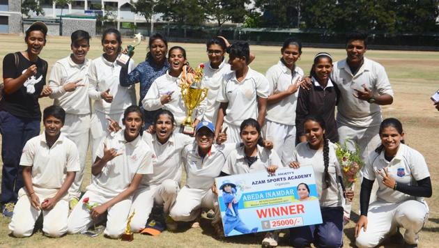 Azam Sports Academy with their trophy after winning the all India Abeda Inamdar invitational women’s cricket tournament at Azam campus ground on Sunday.(Shankar Narayan/HT PHOTO)