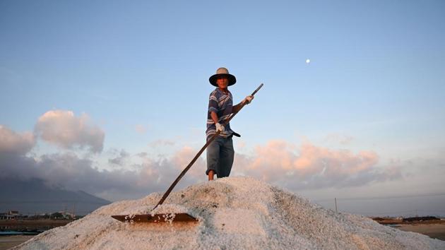 A worker harvests salt in southern Vietnam's Hon Khoi salt fields. Like their ancestors, the salt farmers of the area rise before dawn each day, fan out across shallow seawater pools o harvest the precious mineral, in the hope for a better season than the last. Amid punishing work and unstable incomes, the farmers work under increasingly unpredictable weather patterns to make a living. (Manan Vatsyayana / AFP) A worker harvests salt in southern Vietnam's Hon Khoi salt fields. Like their ancestors, the salt farmers of the area rise before dawn each day, fan out across shallow seawater pools o harvest the precious mineral, in the hope for a better season than the last. Amid punishing work and unstable incomes, the farmers work under increasingly unpredictable weather patterns to make a living. (Manan Vatsyayana / AFP)