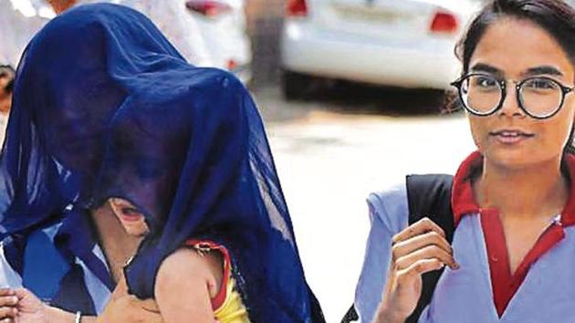 A woman shields her child from the sun on Monday, when the day temperature soared in Gurugram(Yogesh Kumar /HT)